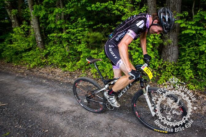Sam Koerber pushes hard up a gravel ascent.