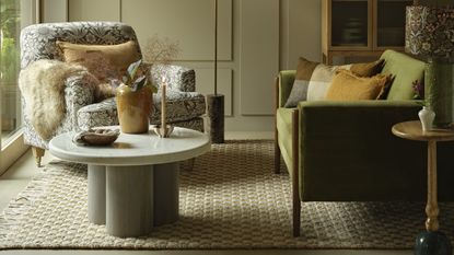 A living room with a green Habitat sofa and a Morris Co armchair