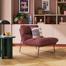 Dunelm Elements Finn Textured Sherpa Occasional Armchair in a living room with a glossy green side table and pink built-in bookcases behind