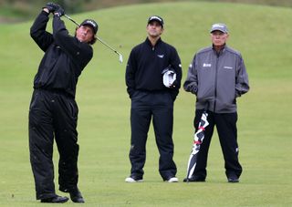 Mickelson hits a shot while Claude and Butch look on