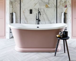 pink bath tub in cream bathroom