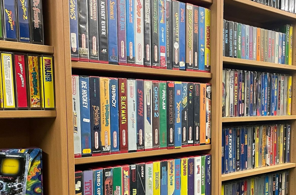 rows of classic games in boxes arranged on wooden shelves