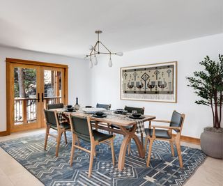 dining room with textile wallhanging and vintage style blue rug and rectangular table