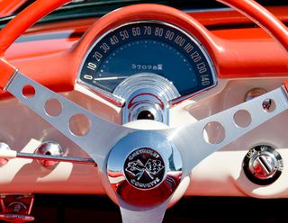 The instrument panel of a 1957 Corvette looks almost art deco with its simple design and use of chrome accents and glass