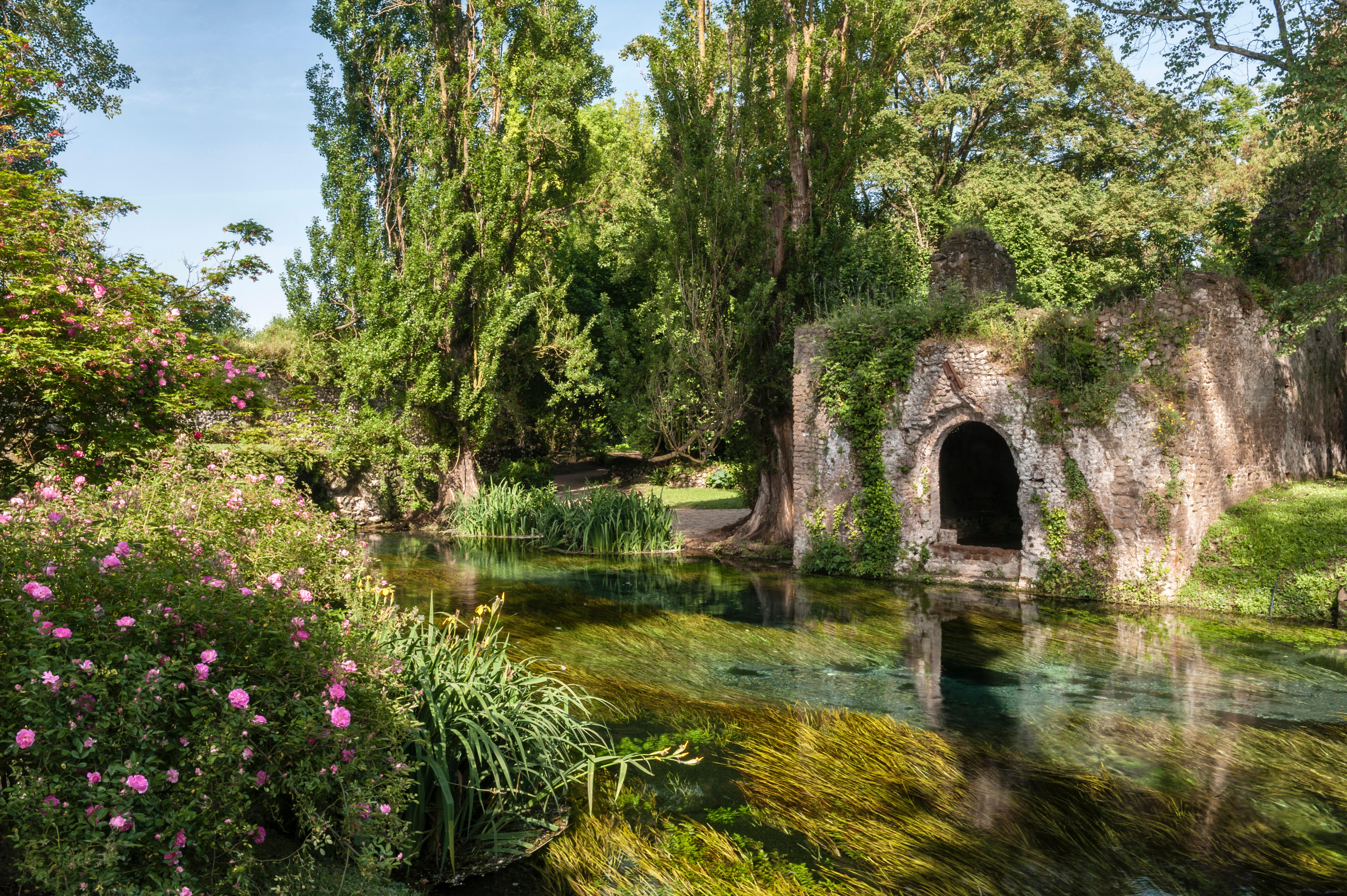 Ninfa, Lazio, Italy. The exceptionally clear water of the river flowing through this spectacular romantic landscape garden is a sight to behold.