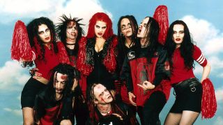 Murderdolls posing with zombie cheerleaders in 2003