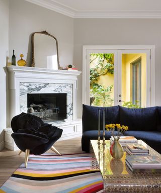 living room with dark blue sofa and fireplace