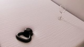 A kettlebell and a wine glass sat on top of the Nectar Premier Copper Mattress during review testing