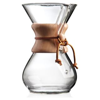 A glass and wooden coffee maker in the shape of an hourglass 