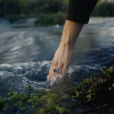 Princess Kate sticking her hand in a stream