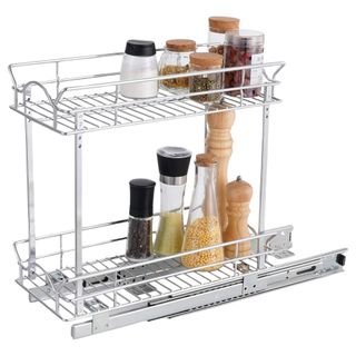 Silver two tier pull out storage for inside cabinets with a few condiments on for illustration