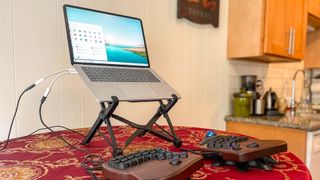 Nexstand Laptop Stand on a desk holding a laptop up