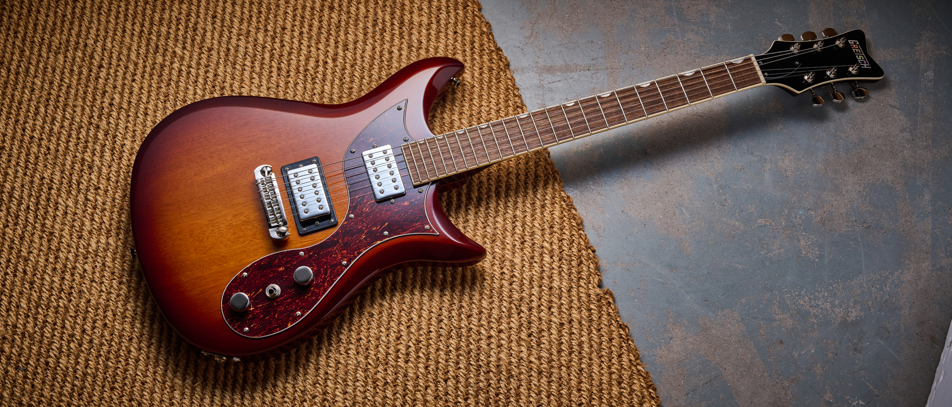 A Gretsch Electromatic CVT electric guitar lying on a rug