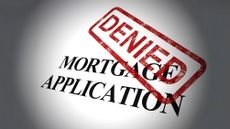 'Denied' stamped in red ink on top of the words mortgage application