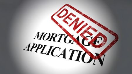 'Denied' stamped in red ink on top of the words mortgage application