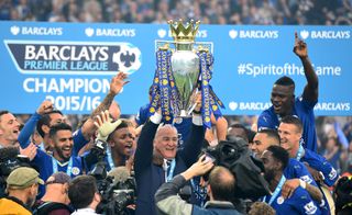 Claudio Ranieri lifts the Premier League trophy during Leicester City's title celebrations after a game against Everton in May 2016.