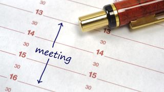 The meeting booked in a diary with pen