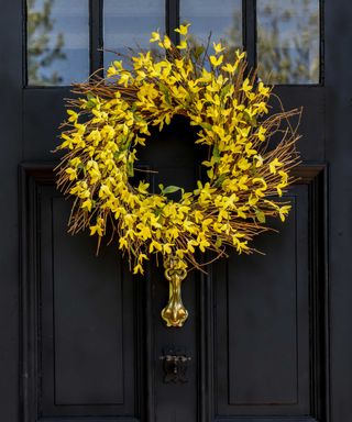 A springtime wreath made with twigs and forsythia spring flowers