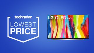 LG C2 OLED TV on a blue background next to TechRadar deals lowest price badge