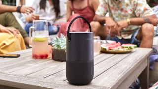 Bose Portable Smart Speaker on a table outdoors