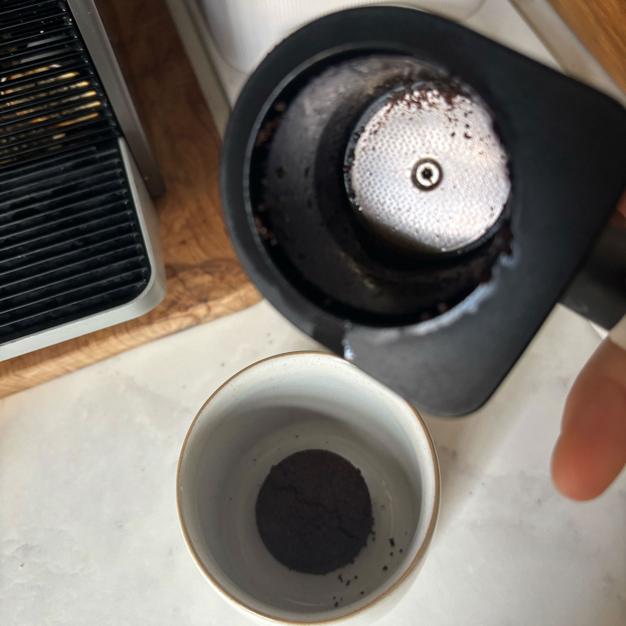 White Philips Baristina portafilter empty of coffee grounds