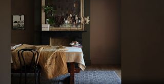 brown dining room with a table covered in must-coloured table linens