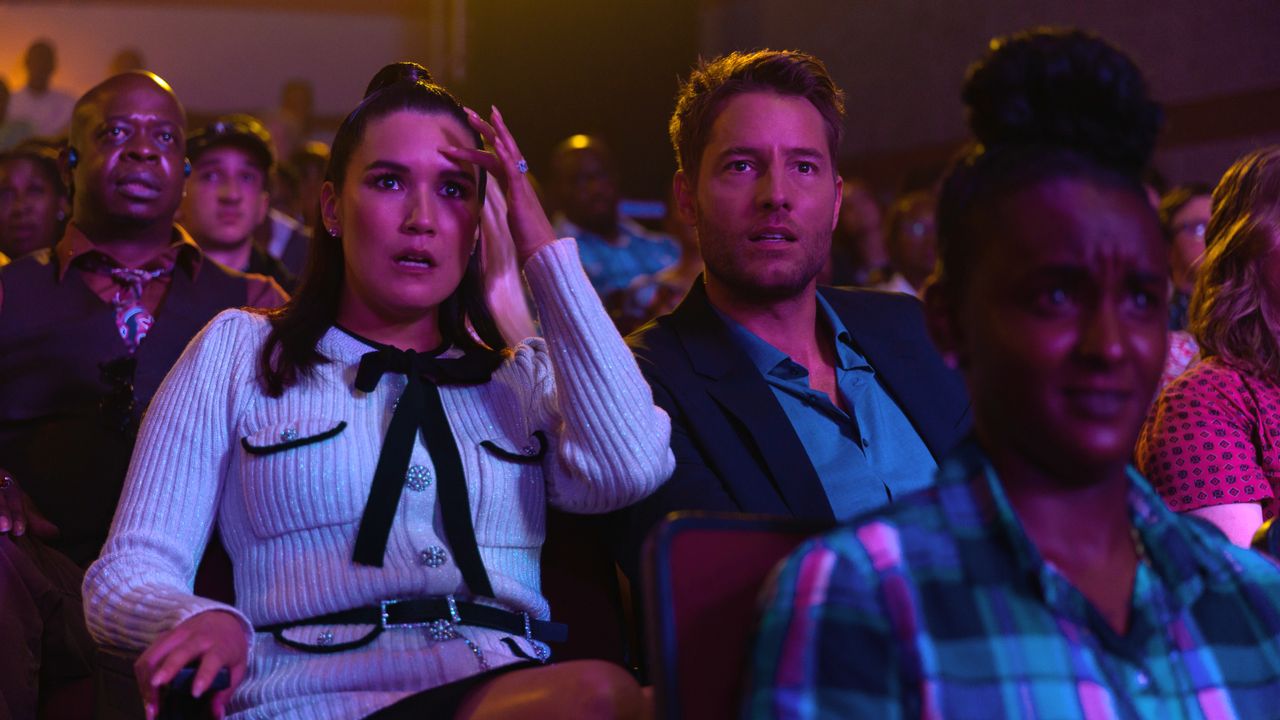 Zoe Chao as Tiffany and Justin Hartley as Blaine, seated in an auditorium in Netflix's Senior Year