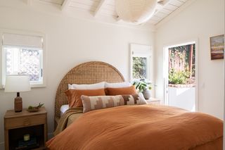 Rustic warm bedroom with rattan headboard