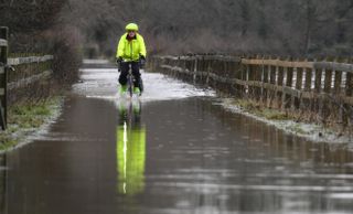 Geoff Nelder rides through a flood