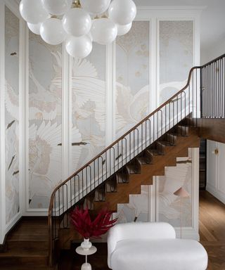 staircase with wallpapered panelling