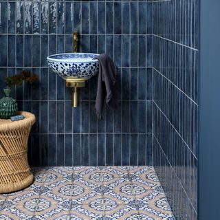 colourful bathroom with petrol blue tiles and floral basin