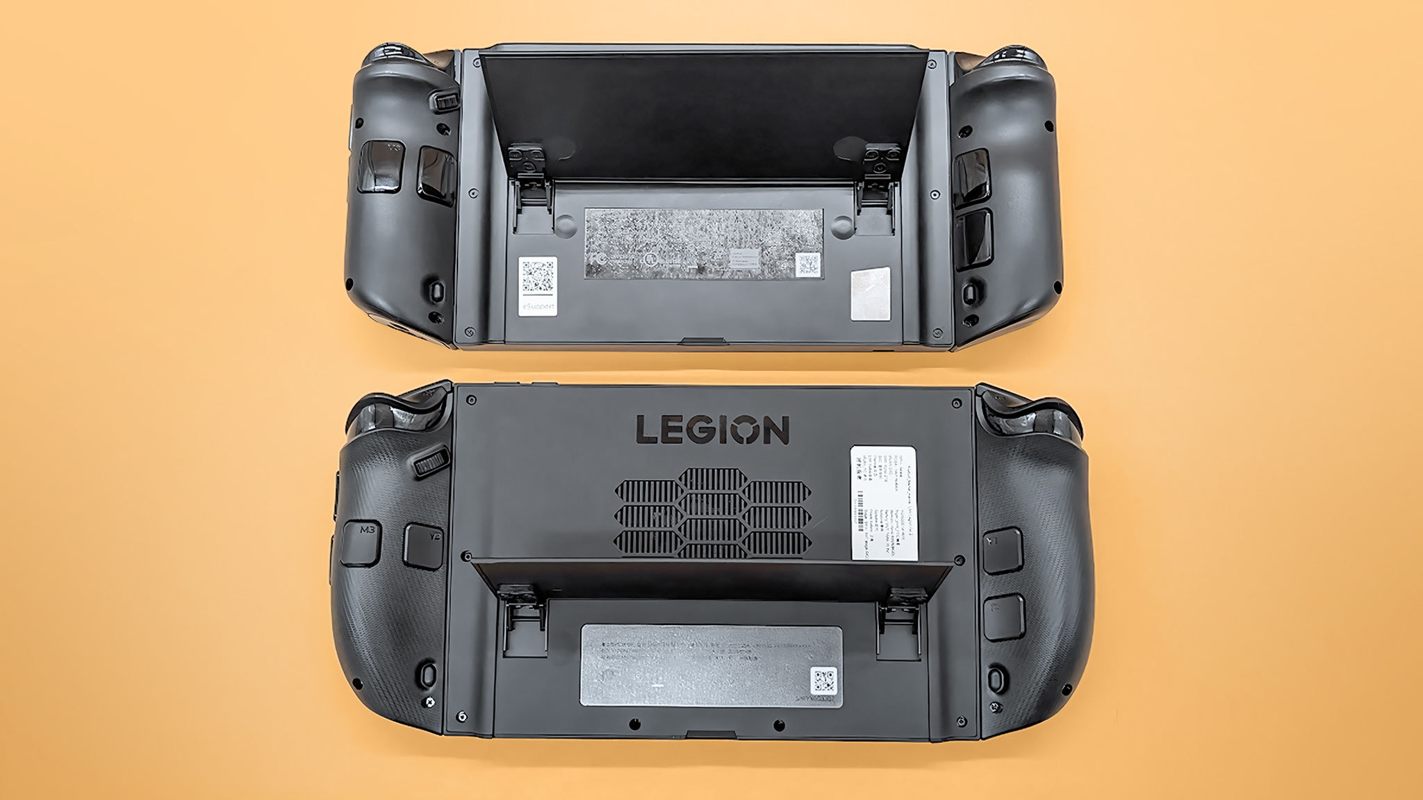 The Lenovo Legion Go 2 and original Legion Go lying face down with kickstands up.