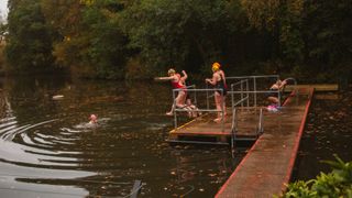 women jumping into Hampstead Heath Ponds