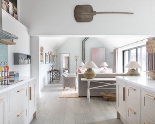 White open plan barn conversion kitchen with seating area in luxurious Cotswolds barn