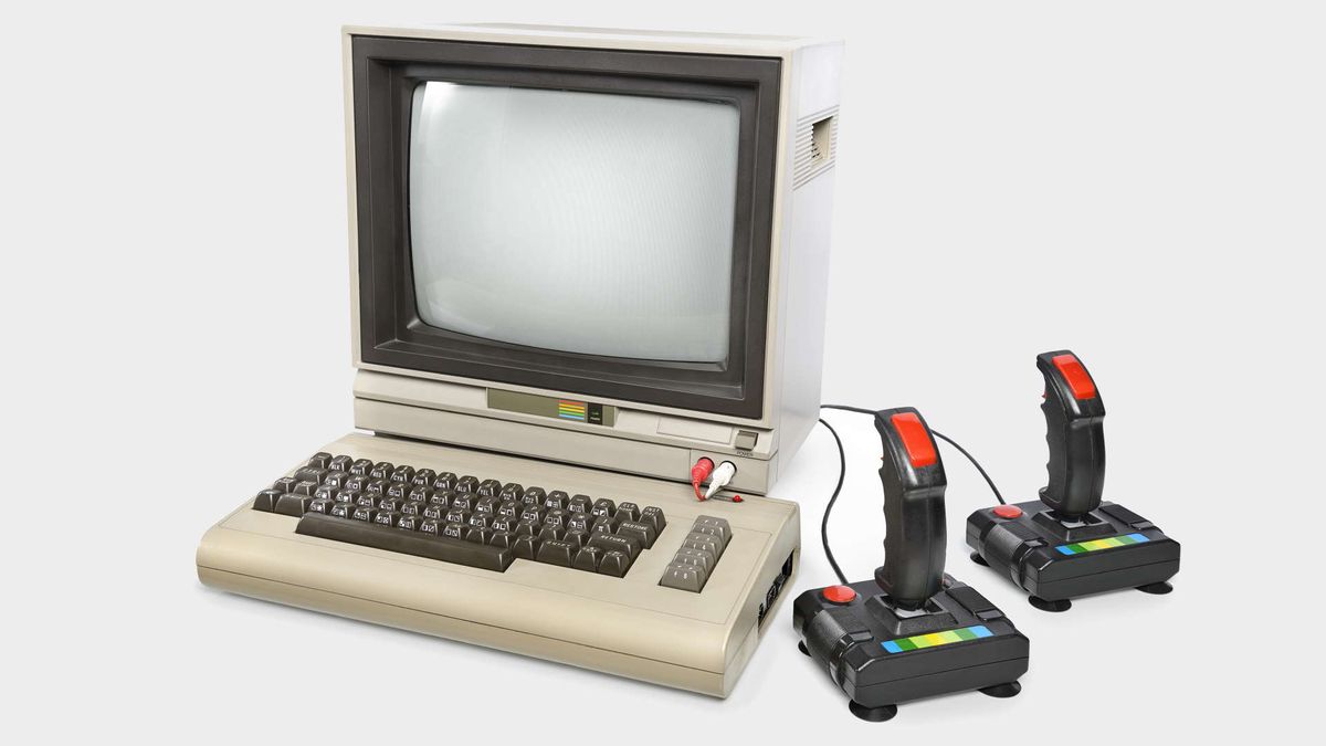 An old computer with a keyboard and two joysticks.