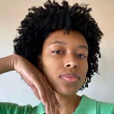 Girl with curly hair posing bare-faced