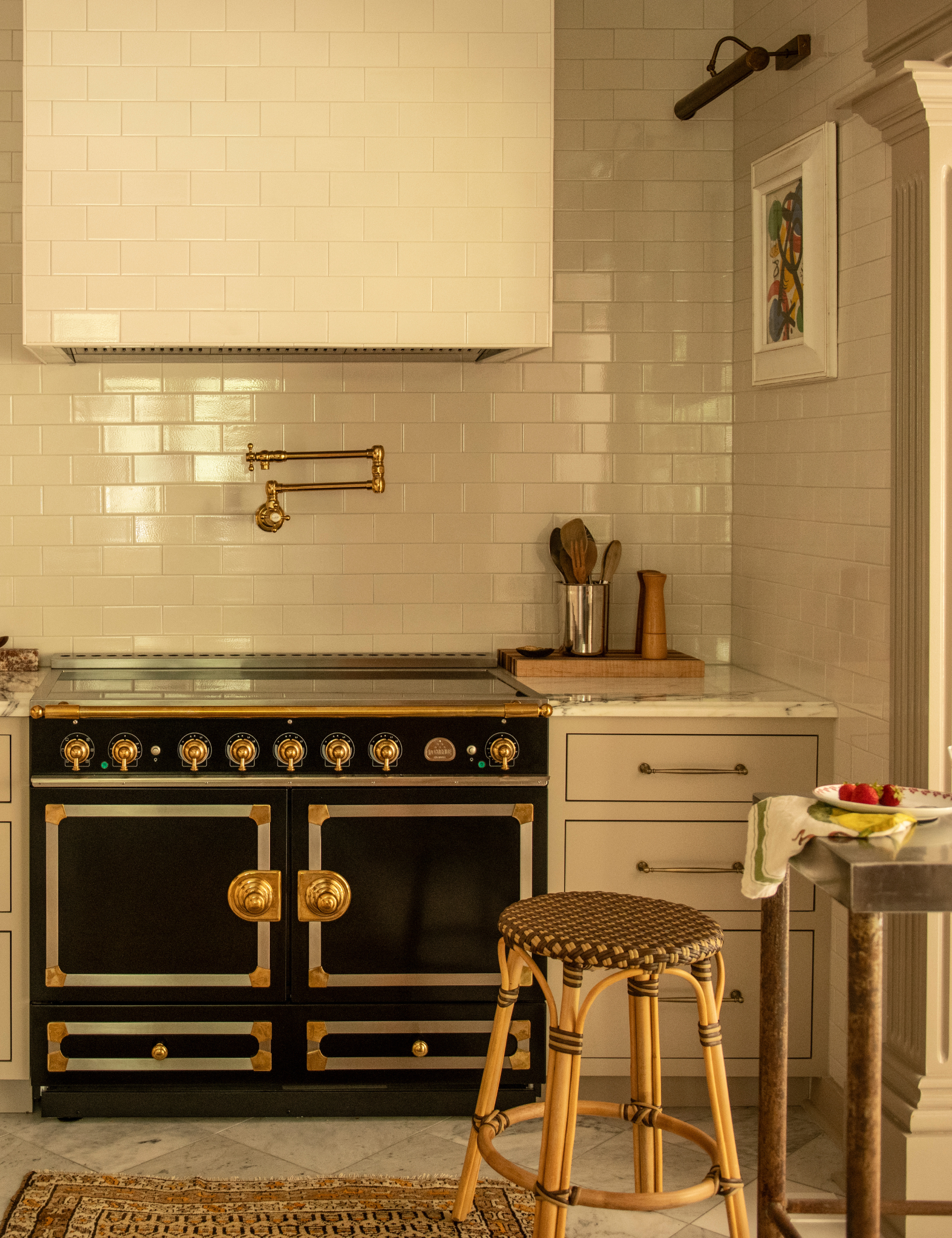Nicole Fisher-designed kitchen featuring subway tiles and a charming antique-style stove