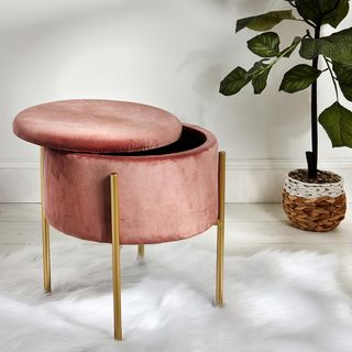 white wall with stool on blush velvet and pink with plant on pot