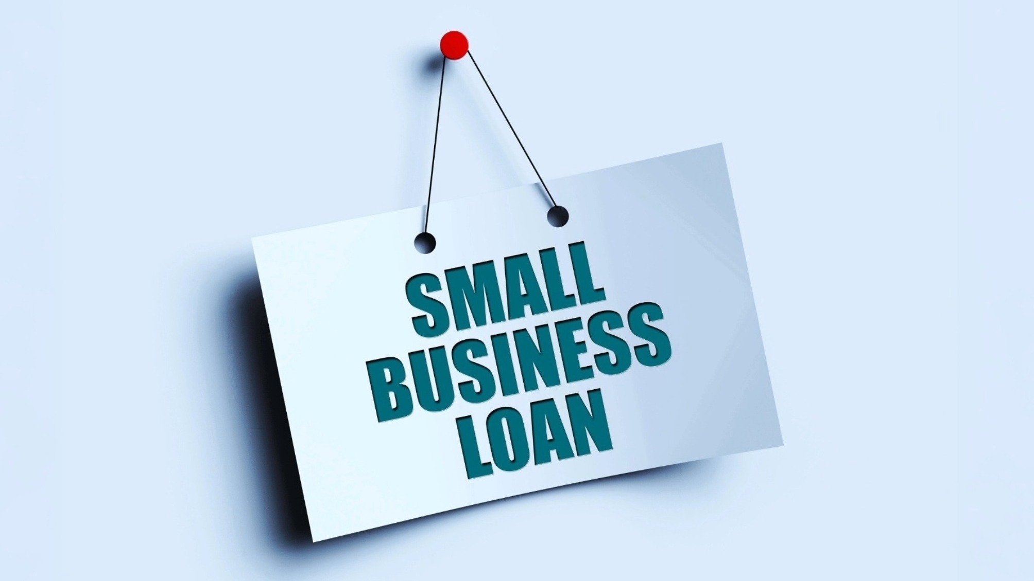 Sign reading 'Small business loan' pinned onto a blue background