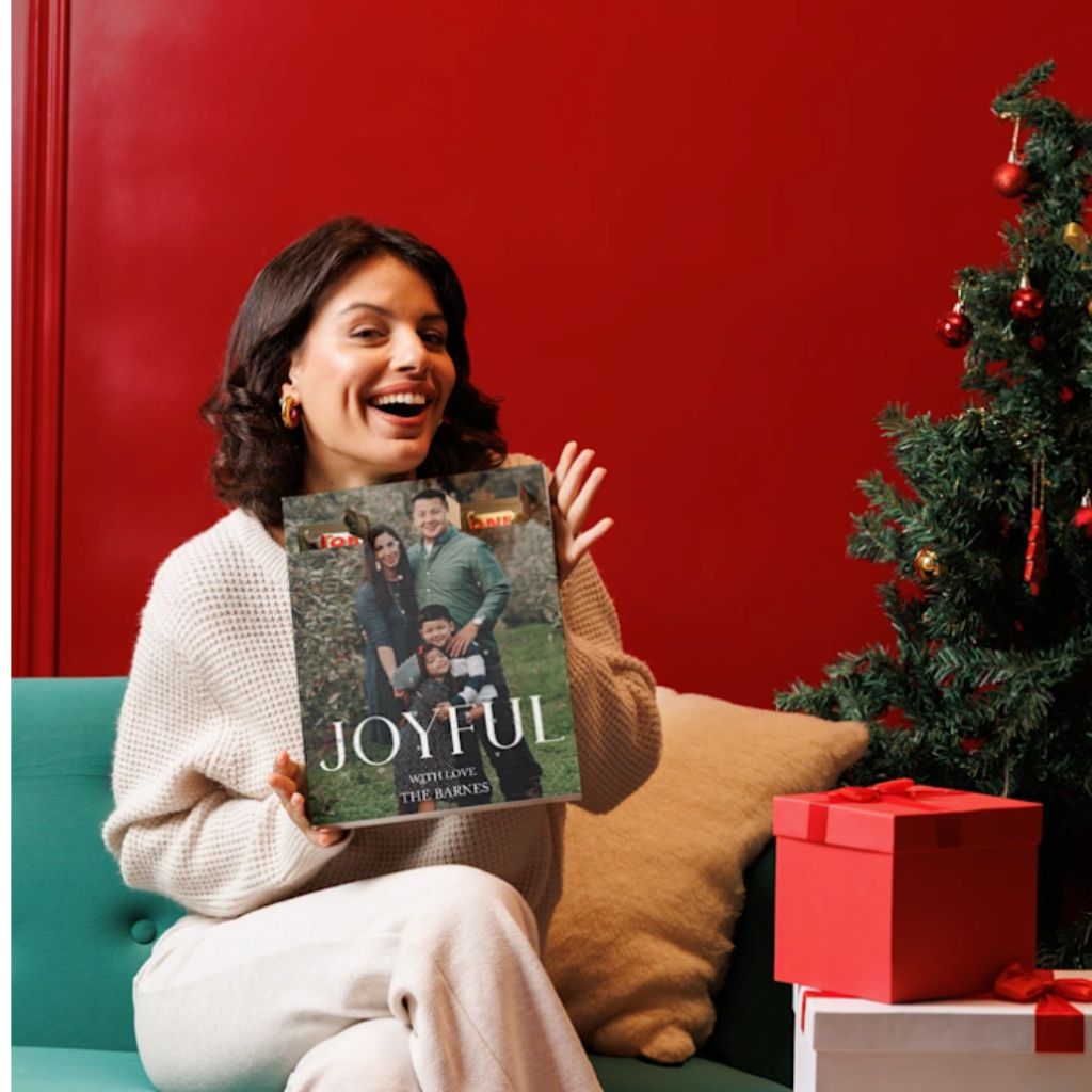 An image of. smiling woman holding the Vistaprint Personalised Advent Calendar