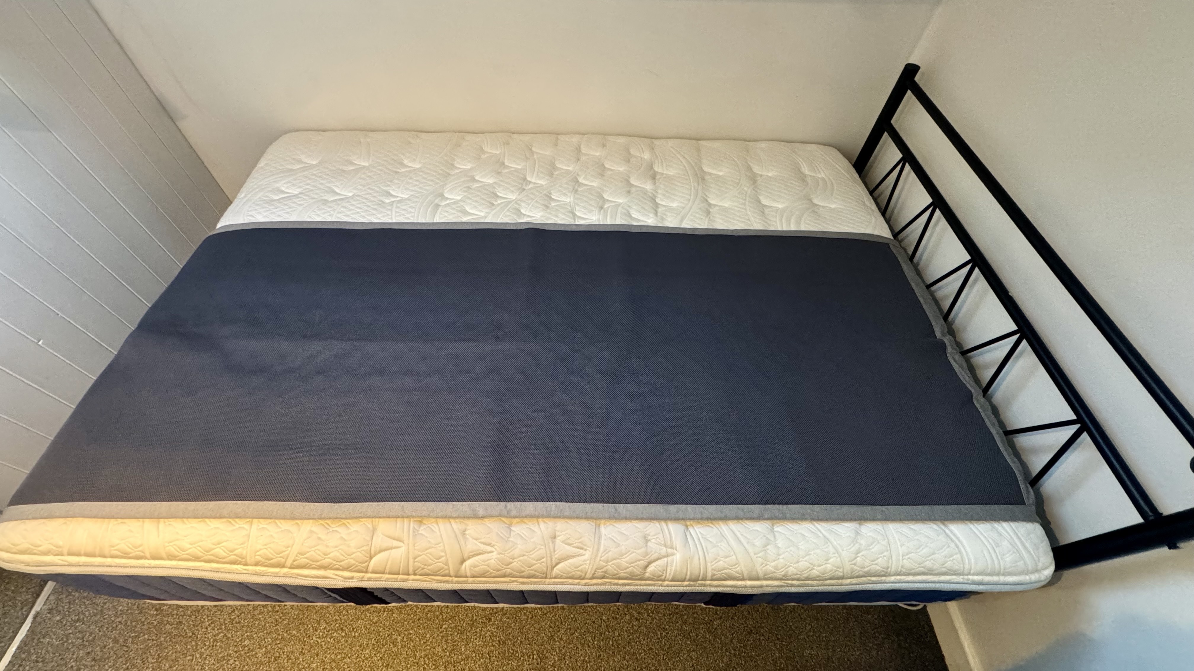 The grey Chilipad Dock Pro Cooling Bed System on mattress in our tester&#039;s bedroom