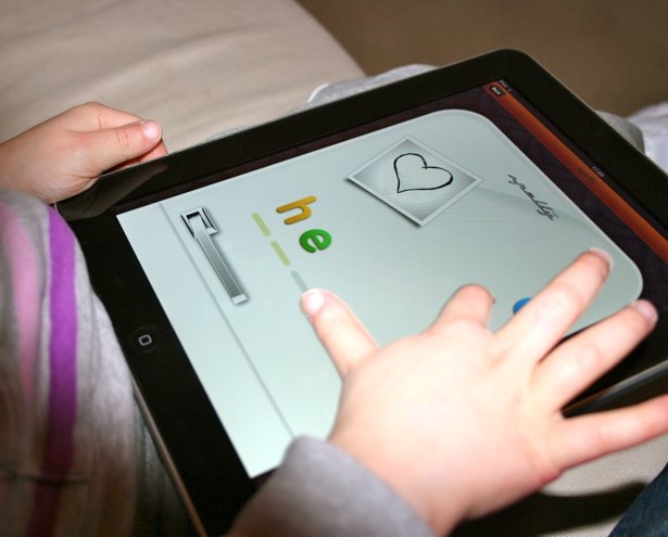 Master of the iOS interface: Alex's little daughter using the Spelly app
