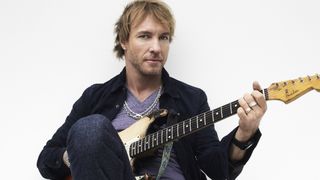 Grammy-winning blues star Kenny Wayne Shepherd frets a chord on a Fender Stratocaster with much of its finish removed from the body.