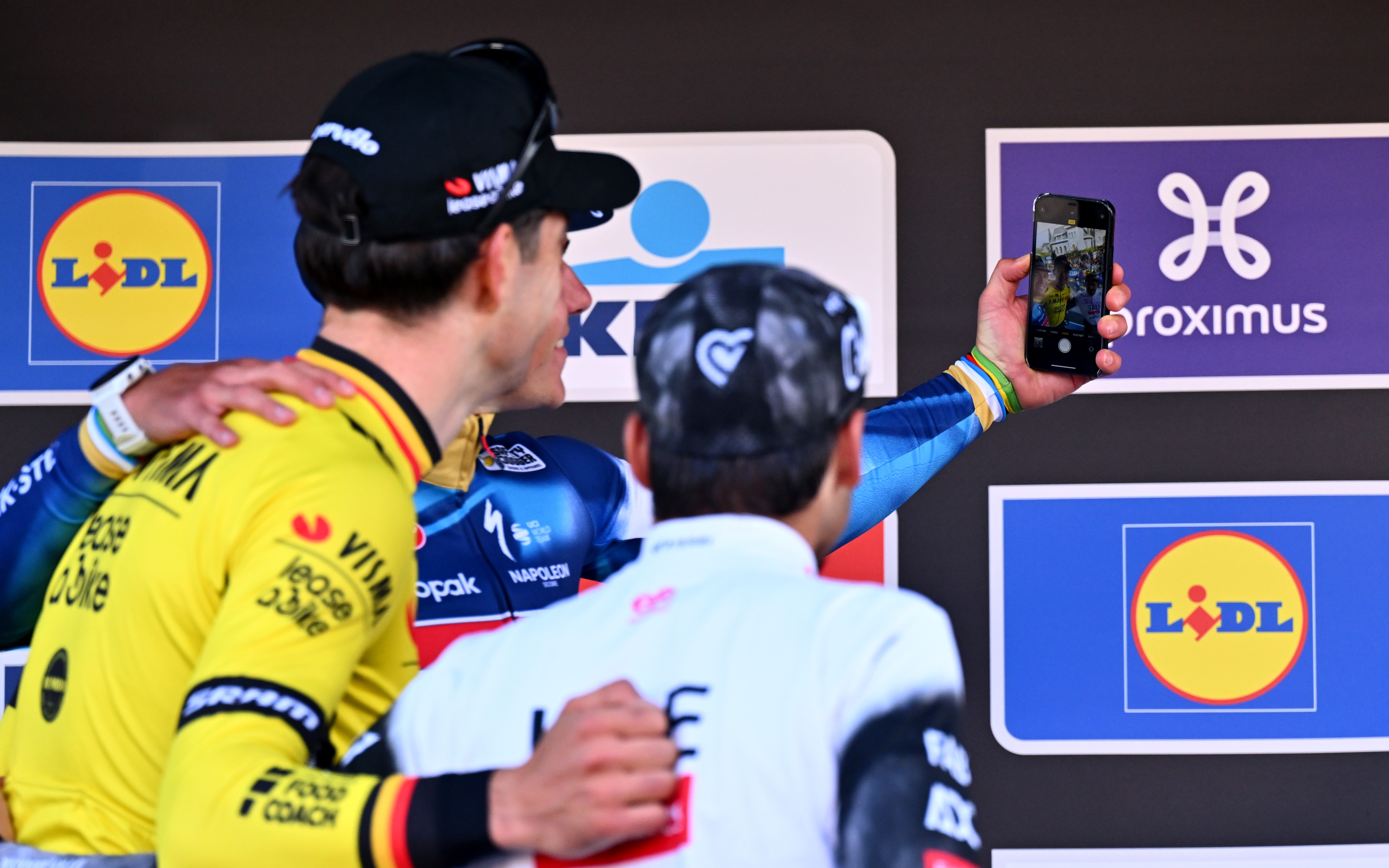 OVERIJSE, BELGIUM - APRIL 18: (L-R) Wout Van Aert of Belgium and Team Visma-Lease a Bike on second place, race winner Remco Evenepoel of Belgium and Team Soudal Quick-Step and Antonio Morgado of Portugal and Team UAE Team Emirates on third place pose and take a selfie on the podium ceremony after the 65th De Brabantse Pijl - La Fleche Brabanconne 2025 - Men's Elite a 162.6km one day race from Beersel to Overijse on April 18, 2025 in Overijse, Belgium. (Photo by Luc Claessen/Getty Images)