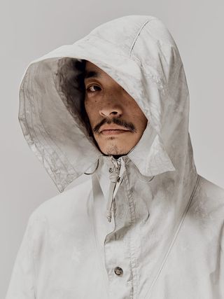 Musician Shinsuke Yamaki wears a white hooded CP Company coat