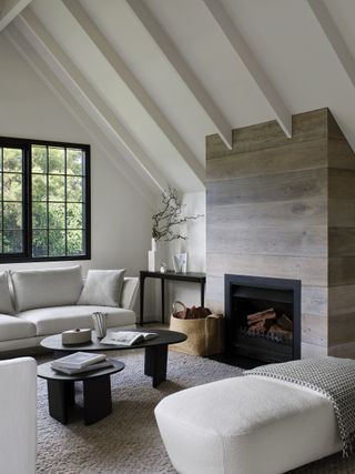 farmhouse style living room with wood clad fireplace and loft ceiling