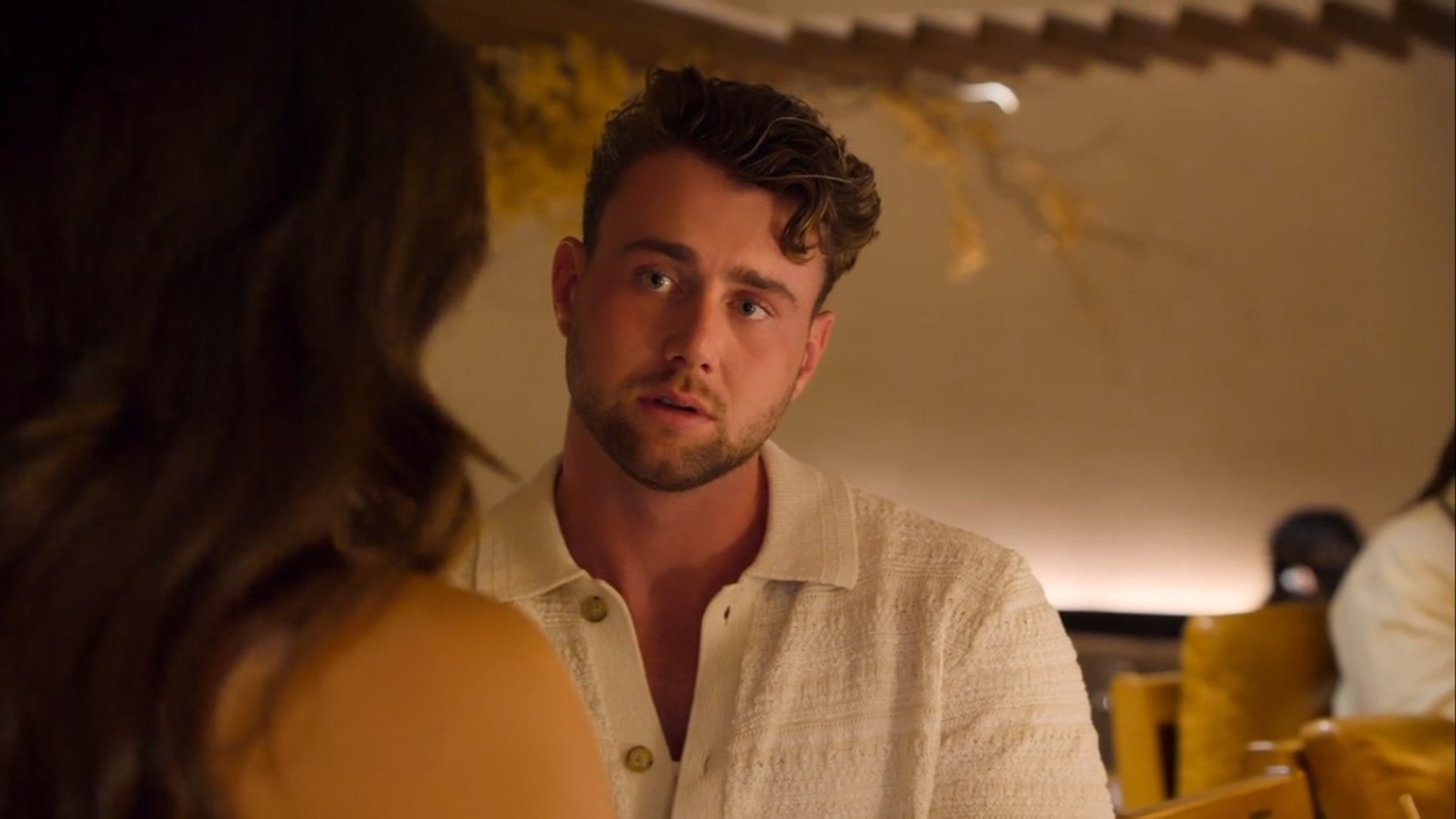 Harry Jowsey talking to a woman in Let's Marry Harry. 