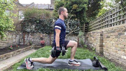 Man performing dumbbell lunges