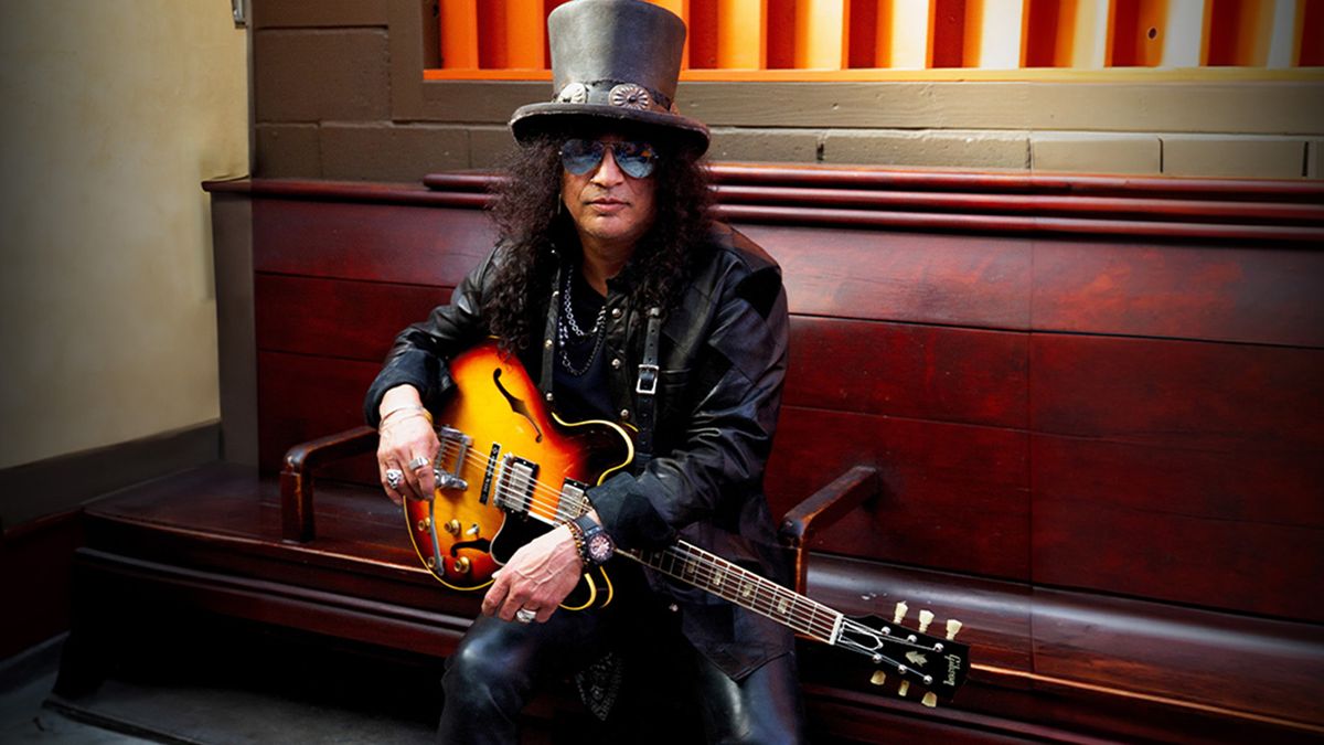 Slash holding his Gibson Custom Shop Slash 1963 Collector&#039;s Edition ES-335 guitar