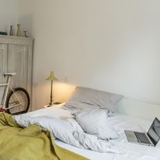 bedroom with bicycle and wardrobe